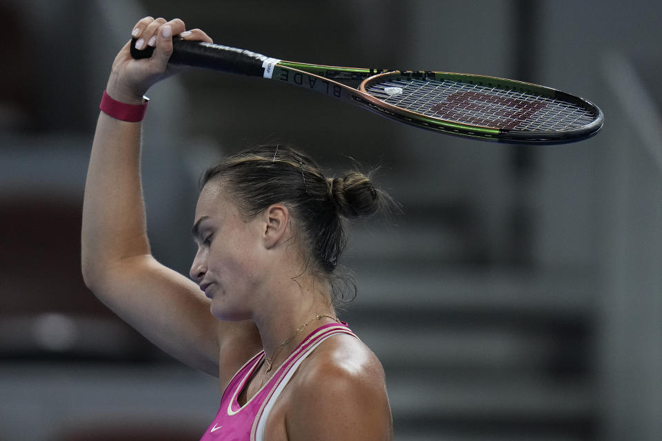 Aryna Sabalenka of Belarus reacts after losing a set point to Elena Rybakina of Kazakhstan during the women's singles quarterfinal match in the China Open tennis tournament at the Diamond Court in Beijing, Friday, Oct. 6, 2023. (AP Photo/Andy Wong)