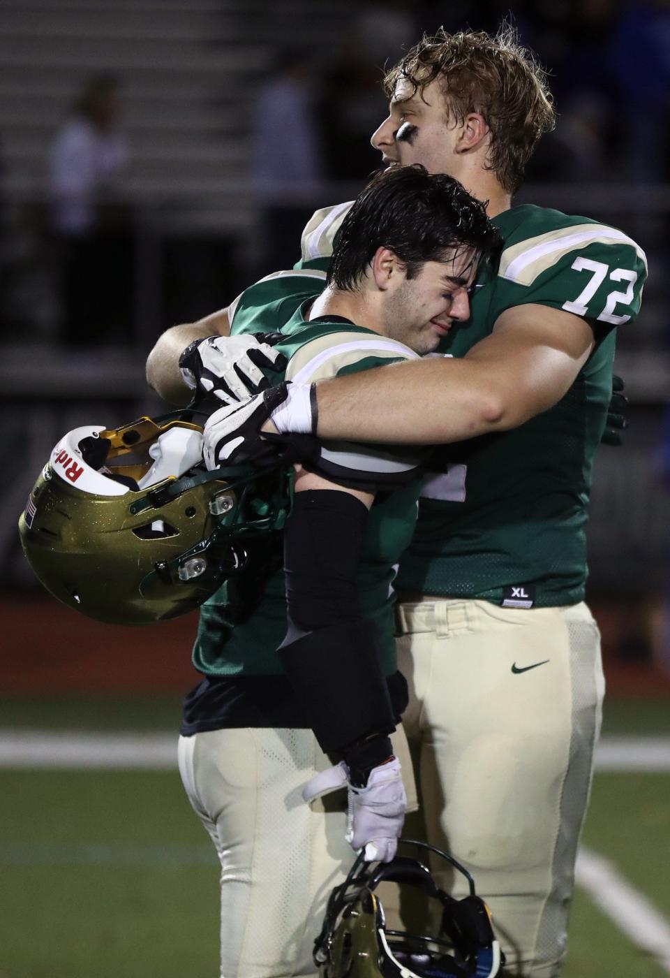 Dublin Jerome's Dane Wleklinski (72) consoles teammate Mike Smith (3) following a 28-14 loss to Olentangy Liberty in an OHSAA Division I Quarterfinal playoff game Nov. 4 at Dublin Jerome High School.