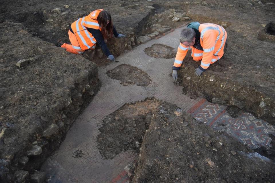 Archaeologists cleaning the edge of the mosaic.