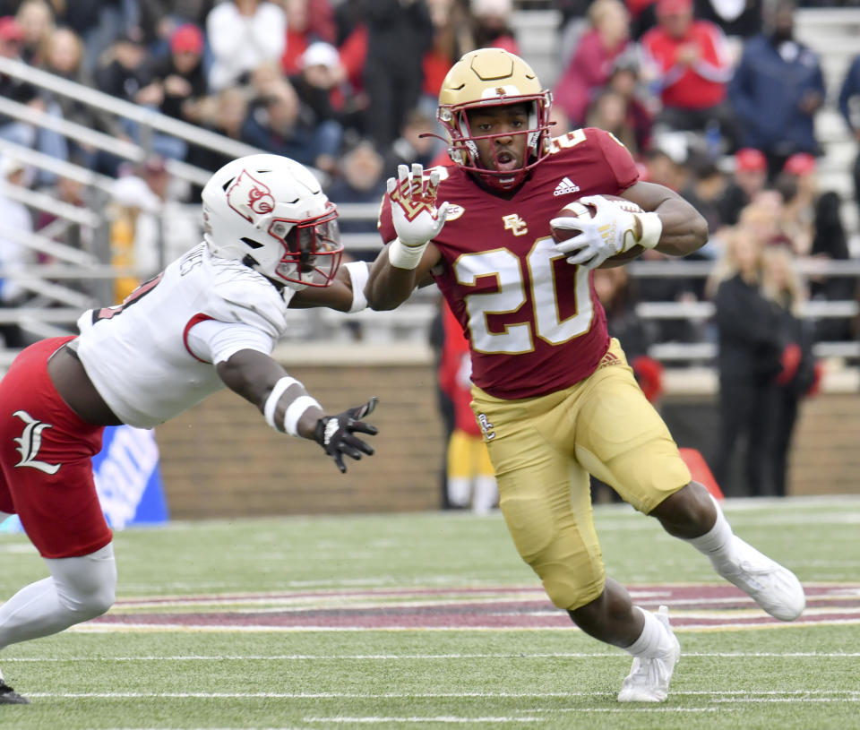 Boston College running back Alex Broome (20) side steps a Louisville defenseman during the first half of an NCAA college football game, Saturday, Oct. 1, 2022, in Boston. (AP Photo/Mark Stockwell)