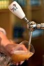 An employee serves a Brugse Zot beer at the Halve Maan brewery in Bruges, Belgium, September 15, 2016. REUTERS/Eric Vidal