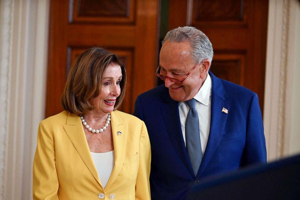 PHOTO: Democratic Representative Nancy Pelosi and Senate Majority Leader Chuck Schumer attend an event on the anniversary of the Inflation Reduction Act in the East Room of the White House in Washington, DC, Aug. 16, 2023. (Jim Watson/AFP via Getty Images)