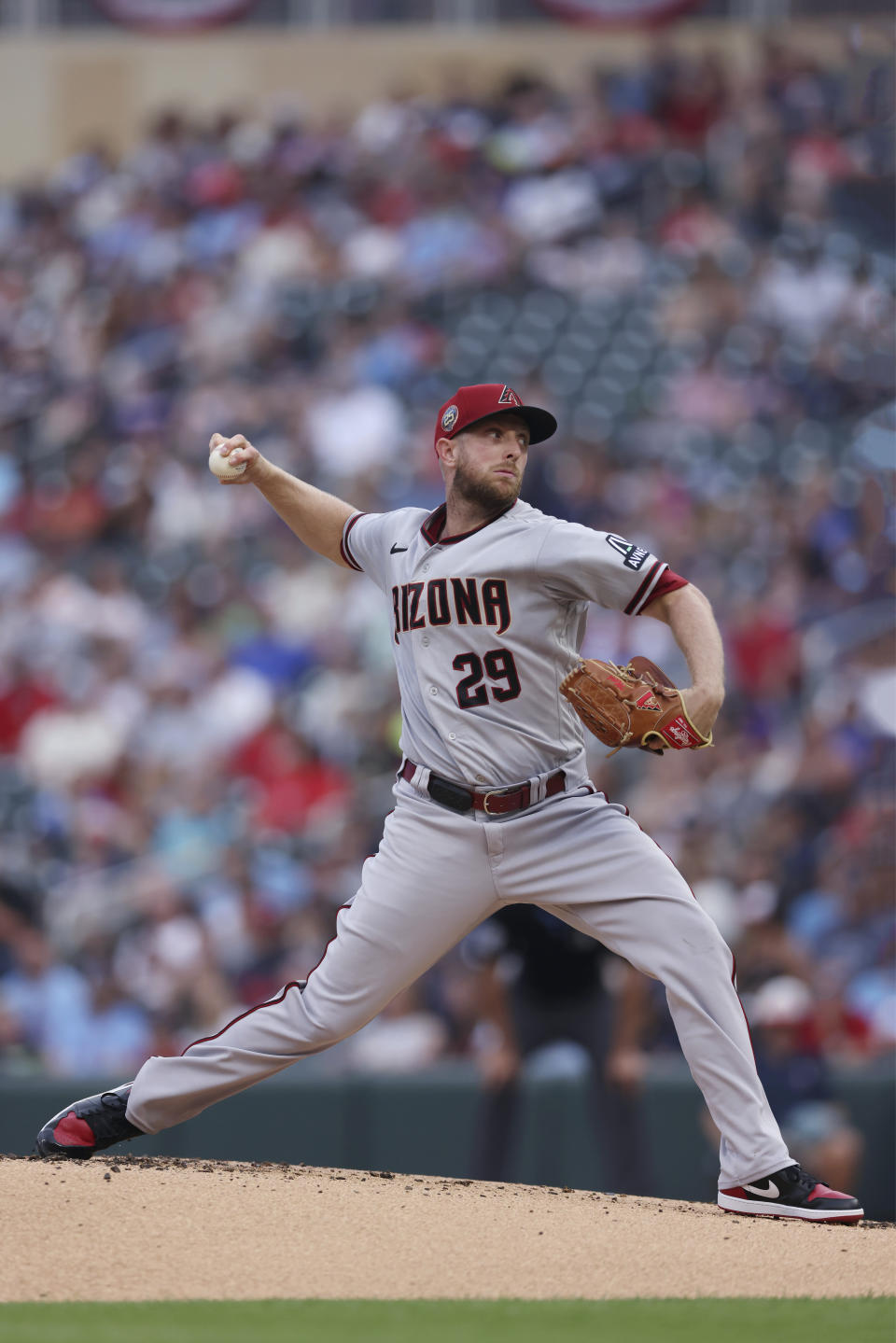 Arizona Diamondbacks pitcher Merrill Kelly throws to a Minnesota Twins batter during the first inning of a baseball game Friday, Aug. 4, 2023, in Minneapolis. (AP Photo/Stacy Bengs)