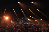 Festivalgoers watch Death Blooms rock band on stage on the first day of Download Festival at Donington Park at Castle Donington, England, Friday June 18, 2021. The three-day music and arts festival is being held as a test event to examine how Covid-19 transmission takes place in crowds, with the the capacity significantly reduced from the normal numbers. (Joe Giddens/PA via AP)