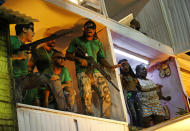 <p>Members from the Beija Flor samba school perform as drug traffickers during Carnival celebrations at the Sambadrome in Rio de Janeiro, Brazil, early Tuesday, Feb. 13, 2018. Brazil’s most famous city has long struggled with violence, particularly in the hundreds of slums controlled by drug traffickers, plus criminal assaults and increasing shootouts between drug traffickers and police. (Photo: Silvia Izquierdo/AP) </p>