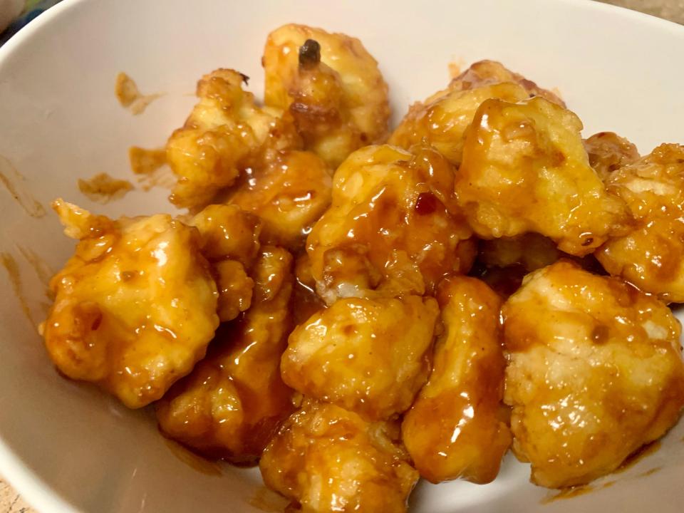 Cooked Trader Joe's Kung Pao tempura cauliflower in a white bowl