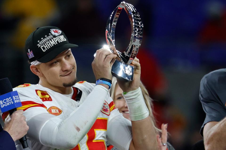 Kansas City Chiefs quarterback Patrick Mahomes (15) celebrates with the Lamar Hunt trophy after the Chiefs' game against the Baltimore Ravens in the AFC Championship football game at M&T Bank Stadium.