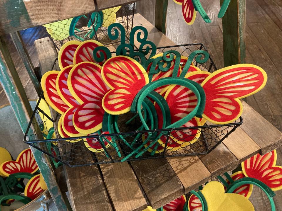 Green headbands with red and yellow butterfly wings attached at Dollywood