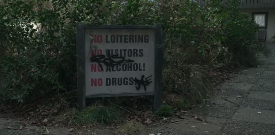 The sign outside Alex's transitional housing says, "No Loitering," "No Visitors," "No Alcohol!" and "No Drugs!"