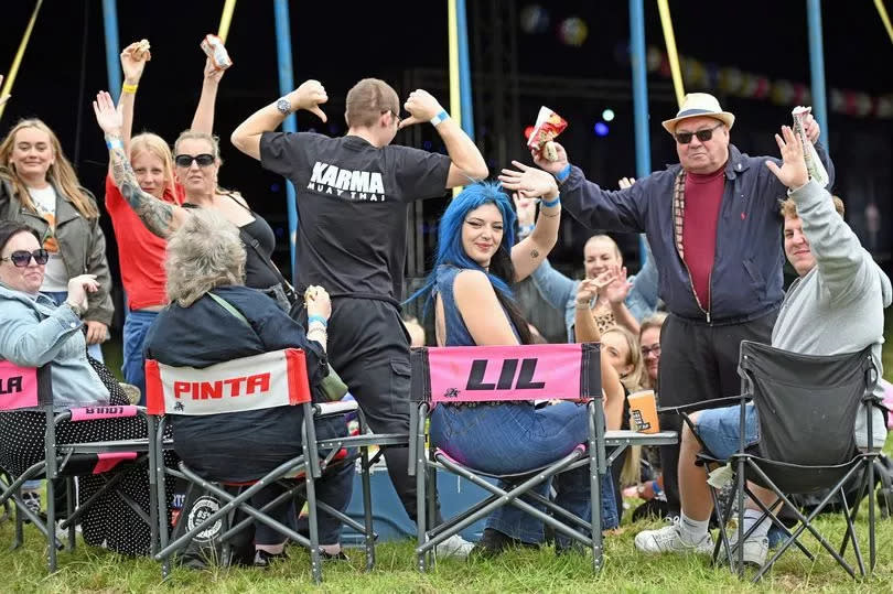 People raising their hands at an event