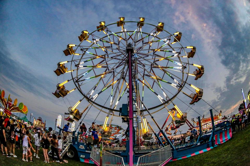 The Ferris Wheel contrasts against the evening sky at the Manitowoc County Fair, Thursday, August 26, 2021, in Manitowoc.