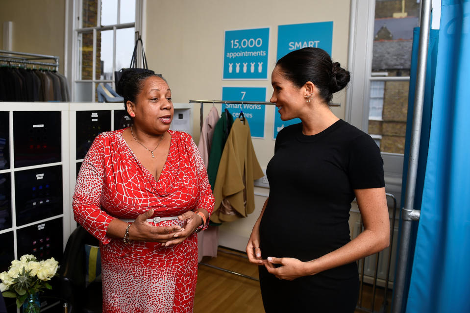 Britain's Meghan, the Duchess of Sussex, chats with Patsy Wardally as they pick out clothes, during her visit to Smart Works, a charity to which she has become patron, at St Charles hospital in west London on January 10, 2019. (Photo by CLODAGH KILCOYNE / POOL / AFP)        (Photo credit should read CLODAGH KILCOYNE/AFP via Getty Images)