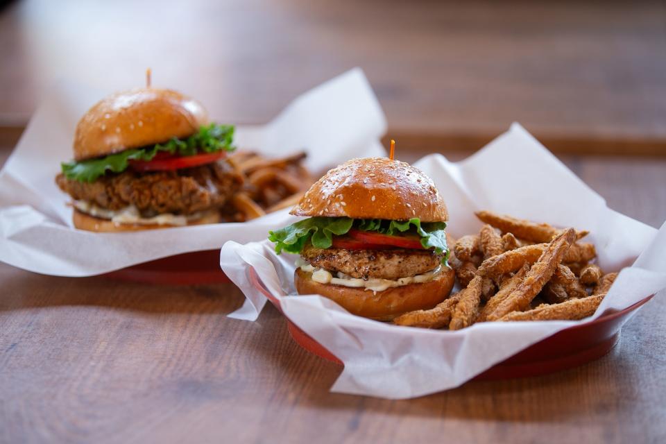 The Fried Chicken Sandwich and Surf N Bird, a grilled chicken sandwich, are displayed at Executive Surf Club Thursday, Jan. 4, 2024.