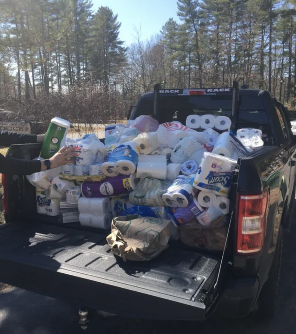 The bed of a trunk is filled with toilet paper