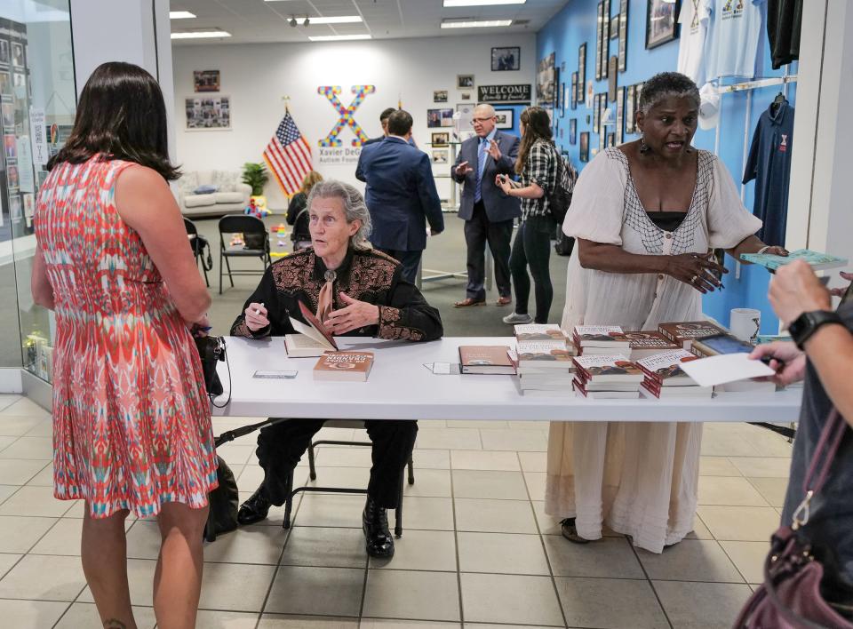 Mary Temple Grandin signs books at the Xavier DeGroat Autism Foundation Museum in the Meridian Mall Friday, July 8, 2022.