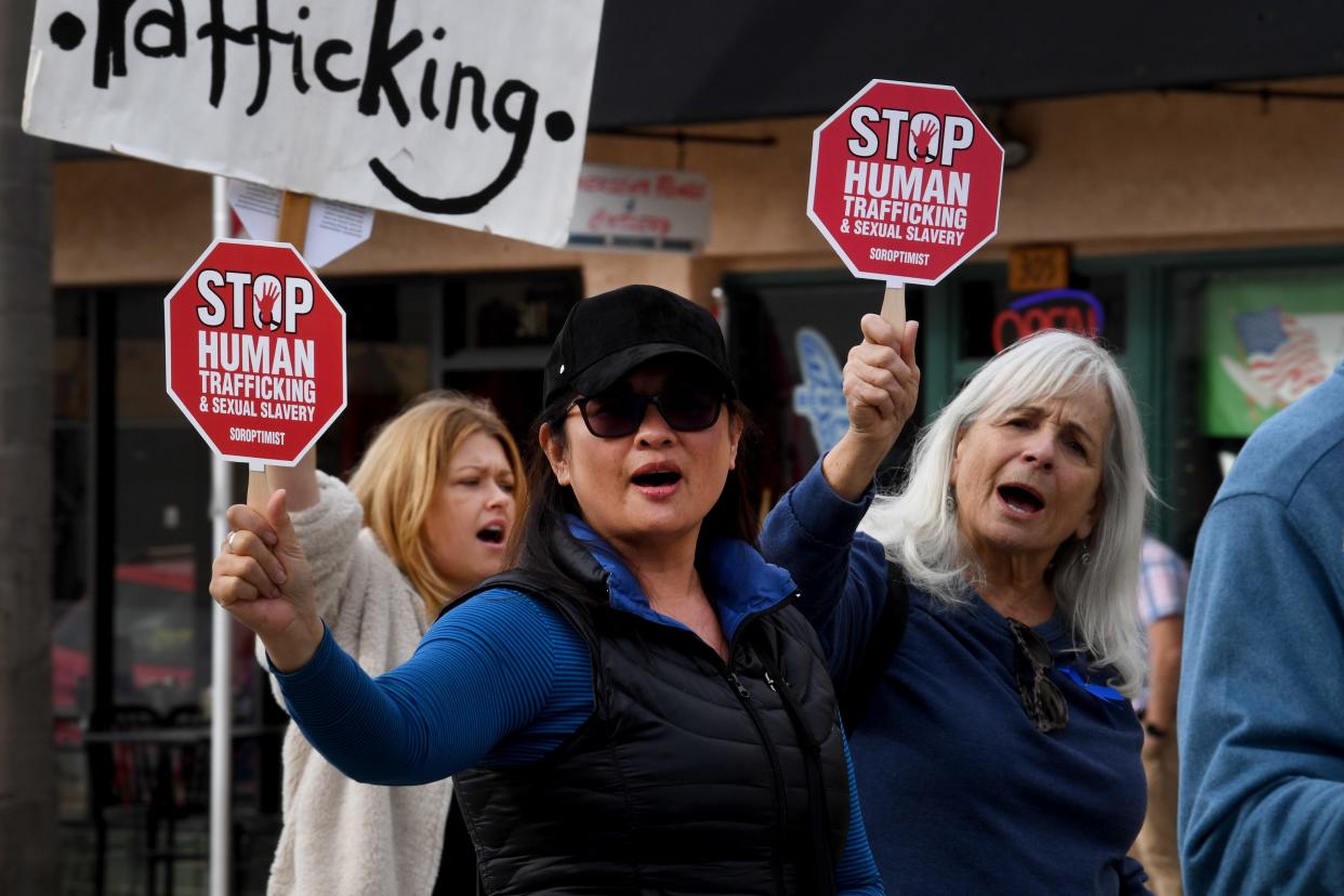 During a 2023 Soroptimist International walk to raise awareness of human trafficking in Ventura, Cathy Trevino, of Oxnard, from left, Gladys Ochango, of Camarillo, and Ashley Pierce, of Ventura, carry signs.