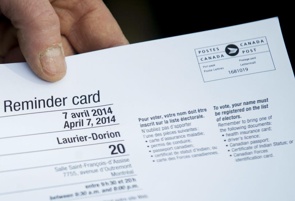 A man holds a voting card outside a polling station in Montreal Monday, April 7, 2014 prior to casting his ballot on election day in Quebec. Quebec's main separatist party faces a tough challenge of its own making Monday as polls opened in elections that revived the debate on whether the French-speaking province should break away from Canada. That possibility now seems far off, with the Party Quebecois facing a backlash over the renewed talk of independence, an idea that has enjoyed little support in recent years. (AP Photo/The Canadian Press, Graham Hughes)