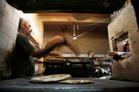 FILE PHOTO - People wait to buy bread inside a government bakery in Damascus, Syria September 17, 2016. REUTERS/Omar Sanadiki/File photo