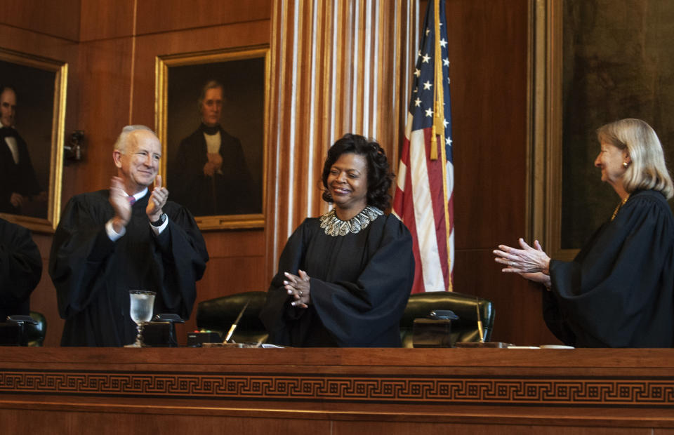 FILE - In this March 7, 2019, file photo, Associate Justices Paul Newby, left, and Robin Hudson, right, applaud for new Chief Justice Cheri Beasley of the N.C. Supreme Court during Beasley's investiture ceremony in Raleigh, N.C. North Carolina's highest court heard arguments Monday, Aug. 26, on the repealed Racial Justice Act, which allowed condemned inmates to seek a life sentence by using statistics to show that race tainted their trials. During the hearing, Chief Justice Beasley said it seemed an attorney was addressing issues greater than what the cases involved and that he was "possibly asking this court to address something greater." (Paul Woolverton/The Fayetteville Observer via AP, File)