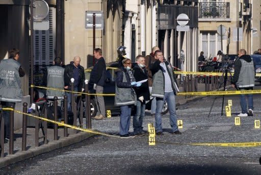 Members of the police scientific unit at work in front of the Indonesian embassy on March 21, 2012 where a bomb exploded causing serious damage to surrounding buildings but no injuries, police said, as investigators sought a motive for the attack