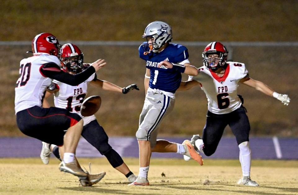 FPD defenders surround Stratford punter Nathan Haskell (1) in the end zone after Haskell bobbled the snap. The punt was blocked and recovered for a touchdown by the Vikings.