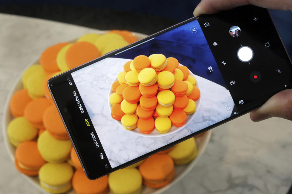 FILE - In this Aug. 7, 2018, file photo, the Samsung Galaxy Note 9 is shown in New York. Retailers are taking back some control of the store experience with smartphone app features that let customers do things like scan and pay, as well as download digital maps. (AP Photo/Richard Drew, File)