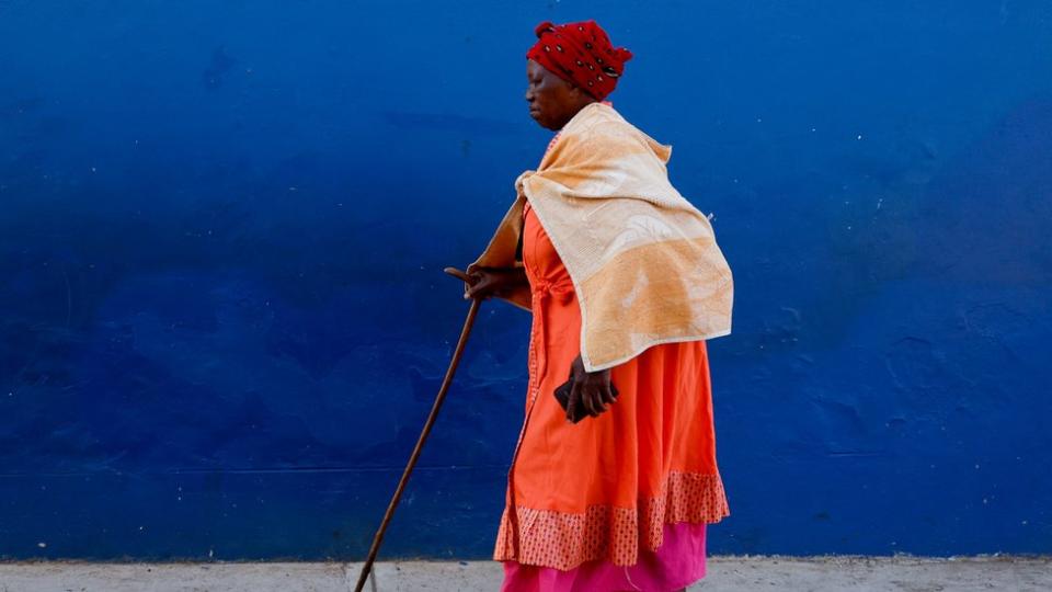 A woman walks, on the day of the South African elections in Nkandla, South Africa, May 29, 2024.