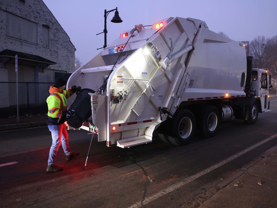 Brockton city workers clean under the School Street bridge where people who are homeless are staying on Tuesday, Dec. 26, 2023.