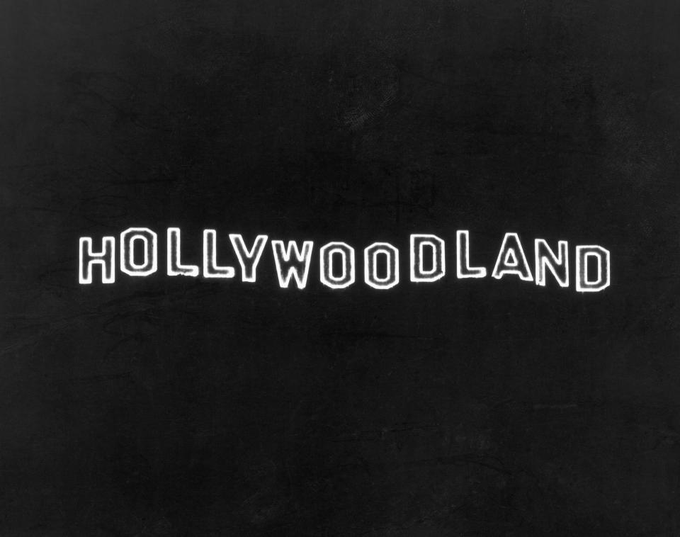 The illuminated Hollywoodland sign at night on Mount Lee in the Hollywood Hills, overlooking Hollywood in Los Angeles, California.
