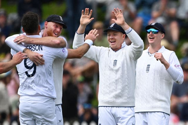 James Anderson, left, is embraced by team-mate Ben Stokes