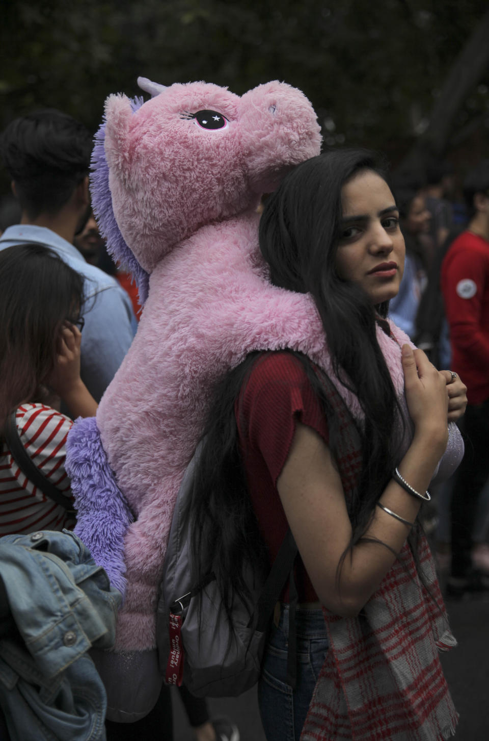 A participant looks on as members of the LGBTQ community and their supporters march during the annual Delhi Queer Pride parade in New Delhi, India, Sunday, Nov.24, 2019. More than 1,000 members of the LGBTQ community and their supporters marched through New Delhi to celebrate India’s sexual diversity, which they say is progressing but still has a long way to go to become a more accepting place for them. (AP Photo/ Rishabh R. Jain)