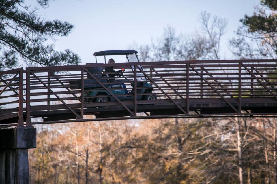 A golf cart crosses an elevated bridge over River Oaks Drive to The Bear at River Oaks. Owners have plans to close the remaining 18 holes to turn into 505 single family unit homes.