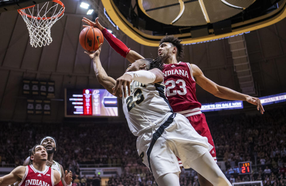 Indiana forward Trayce Jackson-Davis, right, blocks a shot by Purdue guard Jaden Ivey during the second half of an NCAA college basketball game, Saturday, March 5, 2022, in West Lafayette, Ind. (AP Photo/Doug McSchooler)