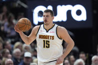 Denver Nuggets center Nikola Jokic (15) brings the ball up court during in the first half of an NBA basketball game against the Utah Jazz Tuesday, April 9, 2024, in Salt Lake City. . (AP Photo/Rick Bowmer)