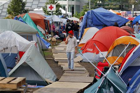 A man walks through the Occupy Boston encampment in Boston, Massachusetts October 11, 2011. REUTERS/Brian Snyder