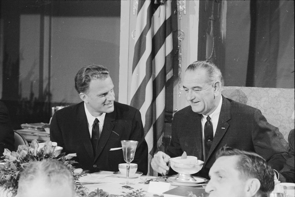 Graham and U.S. President Lyndon B Johnson talk together at the Annual Presidential Prayer Breakfast in Washington, D.C., on&nbsp;Feb. 5, 1964.