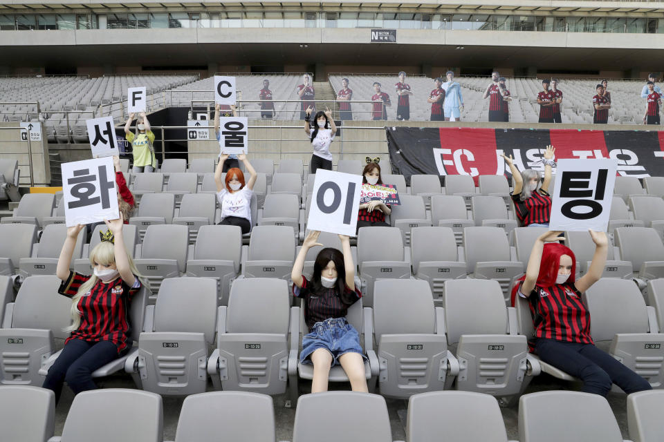 In this May 17, 2020 photo, Cheering mannequins are installed at the empty spectators&#39; seats before the start of soccer match between FC Seoul and Gwangju FC at the Seoul World Cup Stadium in Seoul, South Korea. A South Korean professional soccer club has apologized after being accused of putting sex dolls in empty stands during a match Sunday in Seoul. In a statement, FC Seoul expressed &quot;sincere remorse&quot; over the controversy, but insisted that it used mannequins, not sex dolls, to mimic a home crowd during its 1-0 win over Gwangju FC at the Seoul World Cup stadium. The signs read &quot; Go! FC Seoul.&quot; (Ryu Young-suk/Yonhap via AP)