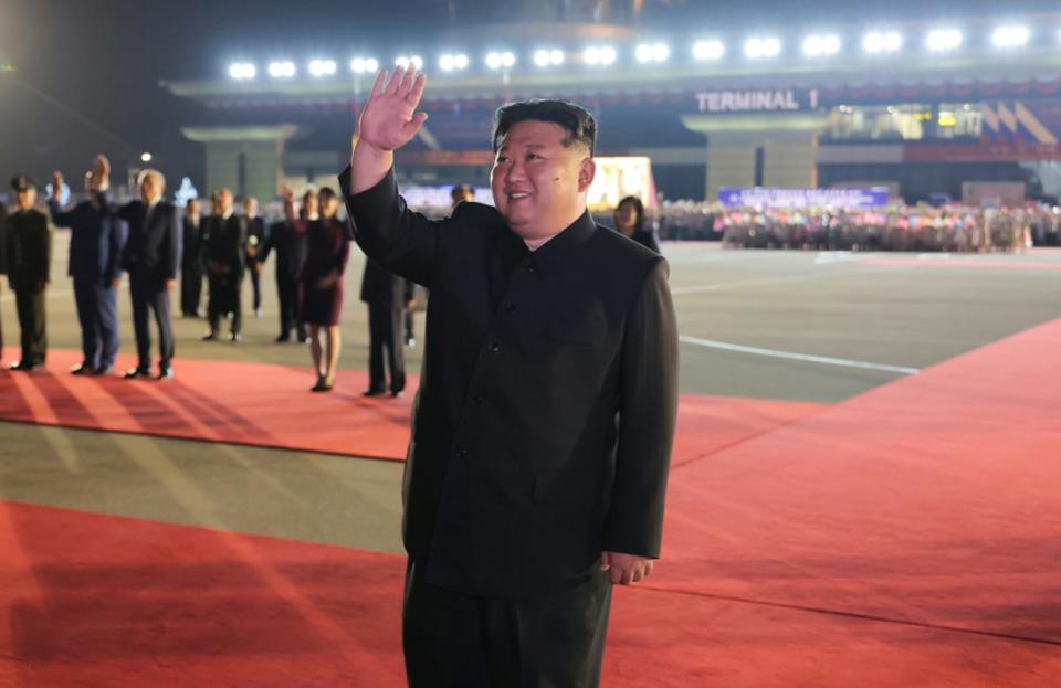 Kim Jong Un waves to Vladimir Putin's plane as the Russian leader departs.