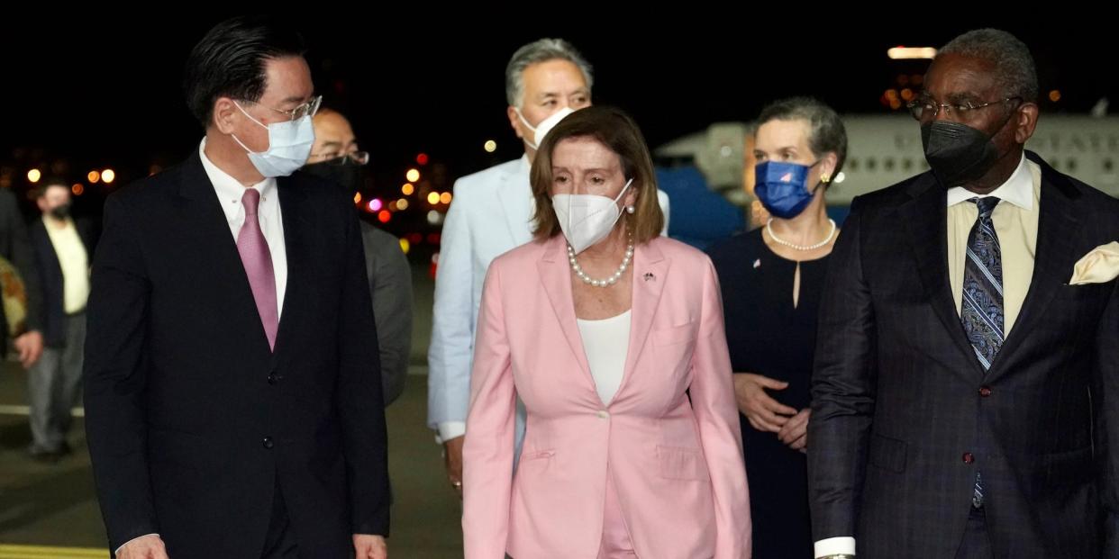 House Speaker Nancy Pelosi walks with Taiwanese Foreign Minister Joseph Wu (left) as she arrives in Taipei, Taiwan, on August 2, 2022.