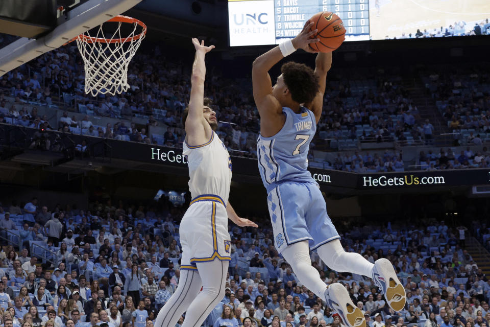 North Carolina guard Seth Trimble (7) drives in to dunk against UC Riverside forward Vladimer Salaridze, left, during the first half of an NCAA college basketball game Friday, Nov. 17, 2023, in Chapel Hill, N.C. (AP Photo/Chris Seward)