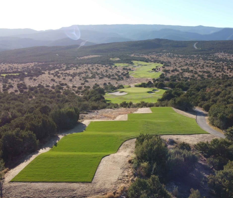 <p>Paako Ridge is twenty-five minutes by car from Albuquerque, NM and tucked 6,500 feet above sea level—it’s bombs away in the thin air of the Land of Enchantment. You’ll need the extra length (the course plays long no matter the tee box) as fairways climb steep foothills, but they lead to buttes with incredible vistas of the Sandia Mountains (we’re looking at you, No. 17). Of the 27 holes here, no feature is more interesting than the fourth, where a 100-plus-yard green is a shoo-in to be the biggest putting surface you’ll ever encounter.</p>