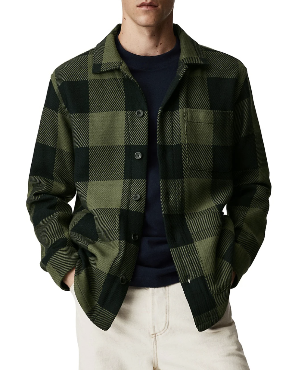 man wearing beige pants and green and black Mango Persac Check Flannel Shacket (photo via The Bay)