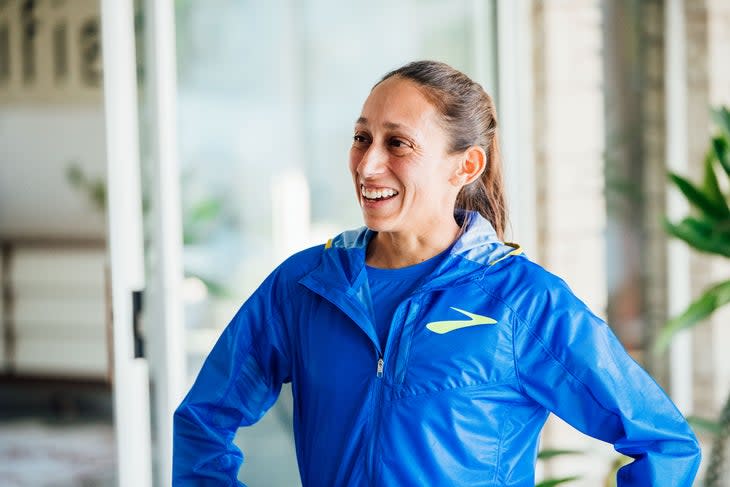 Des Linden smiles with hands on hips ahead of the 2022 Boston Marathon
