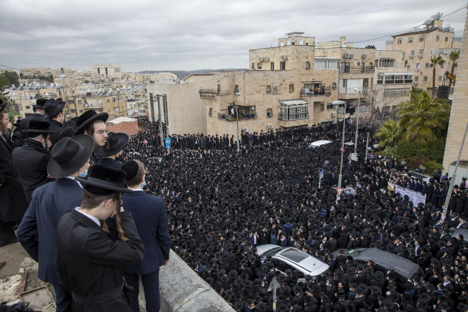 Thousands of ultra-Orthodox Jews participate in funeral for prominent rabbi Meshulam Soloveitchik, in Jerusalem, Sunday, Jan. 31, 2021. The mass ceremony took place despite the country's health regulations banning large public gatherings, during a nationwide lockdown to curb the spread of the virus. (AP Photo/Ariel Schalit)