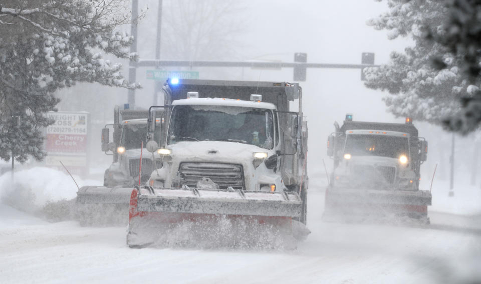 City of Denver snowplows clear the eastbound lanes of Speer Blvd. as a storm packing snow and high winds sweeps in over the region Tuesday, Nov. 26, 2019, in Denver. Stores, schools and government offices were closed or curtailed their hours while on another front, Thanksgiving Day travellers were forced to wrestle with snow-packed roads and flight delays or cancellations throughout the intermountain West. (AP Photo/David Zalubowski)