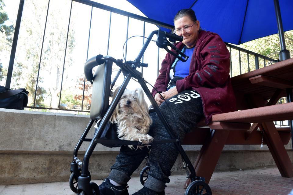 Wendy Rasmussen, 54, sits with her dog after attending the grand opening ceremony of The ARCH homeless shelter on Monday, Jan. 27, 2020, in Ventura. Rasmussen, who has been living in her car for three years, is hoping to be one of the first new clients at the shelter.