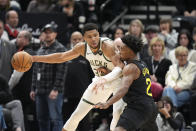 Utah Jazz guard Collin Sexton (2) guards against Milwaukee Bucks forward Giannis Antetokounmpo, left, during the first half of an NBA basketball game Sunday, Feb. 4, 2024, in Salt Lake City. (AP Photo/Rick Bowmer)