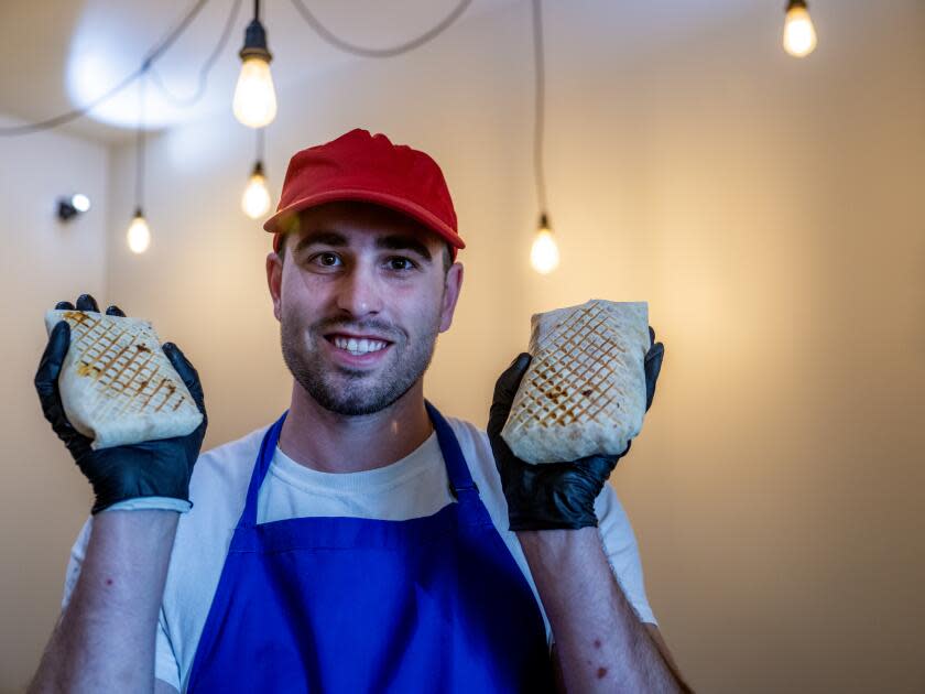 Guillaume Condé holds his signature French tacos, which he calls FrenchFolds.