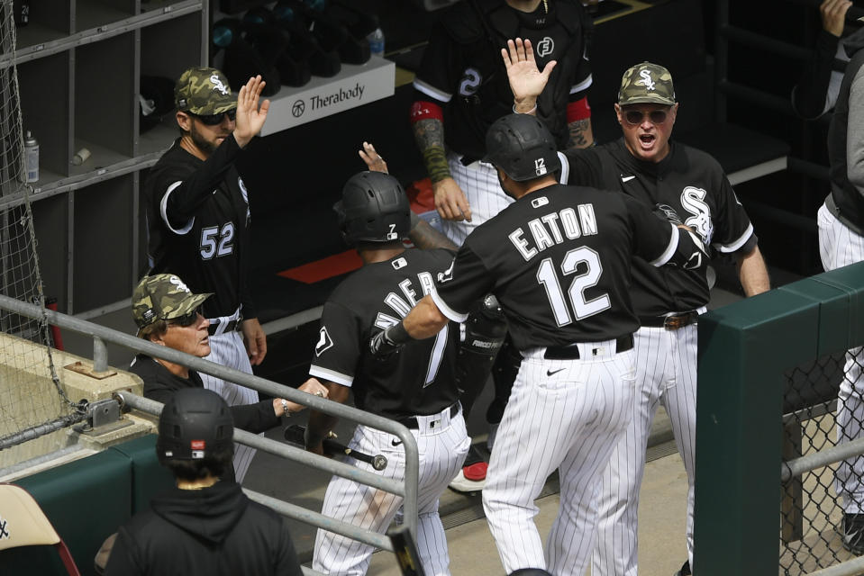 Chicago White Sox's Adam Eaton (12) and Tim Anderson (7) celebrate at the dugout with manager Tony LaRussa left, after Eaton hit a two-run home run during the fifth inning of a baseball game against the Kansas City Royals, Sunday, May 16, 2021, in Chicago. (AP Photo/Paul Beaty)