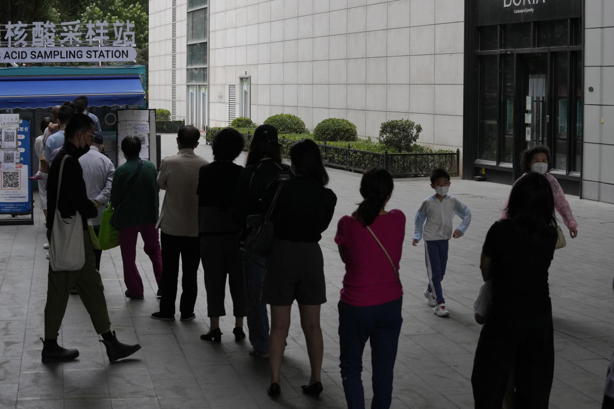 Residents line up for mass COVID tests, Monday, June 13, 2022, in Beijing. (AP Photo/Ng Han Guan)